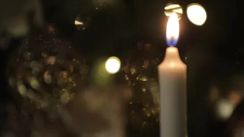 Christmas candle over dark background with lights and ornaments. Stock Footage 251529519