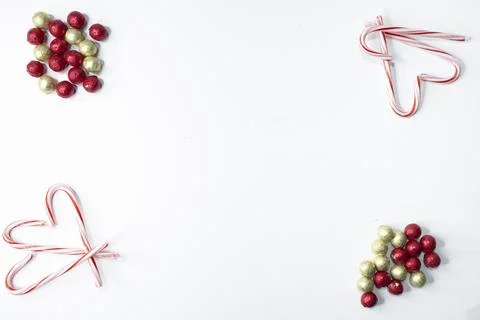 Christmas candy decorations in the corner of a flat lay. Stock Photos
