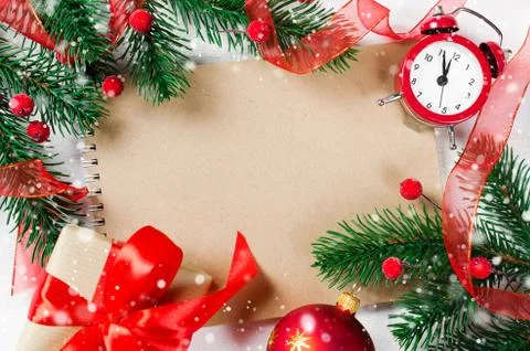 Christmas card with empty notebook and clock. Stock Photos