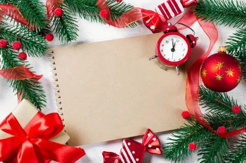 Christmas card with empty notebook and clock. Stock-Fotos