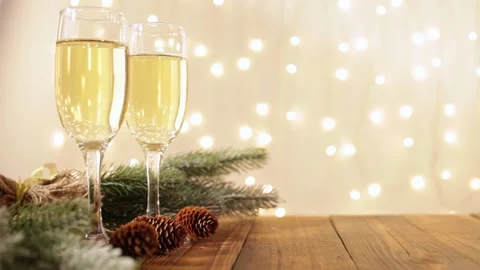 Christmas card, empty place for text, glasses of champagne on a wooden table Stock Footage 140491293
