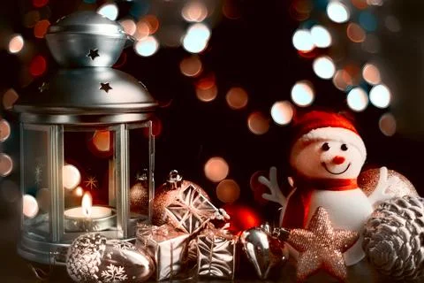 Christmas card: a snowman, a lantern with candles, bright shiny boxes with gi Stock Photos