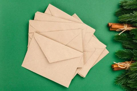 Christmas card from stack of craft envelopes with frame of Christmas decorations Foto stock