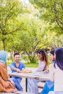 Christmas celebration multiracial group on a table. millennial diverse group Stock Photos