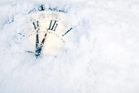 Christmas clock on snow Stock Photos