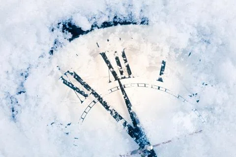 Christmas clock on snow Stock Photos