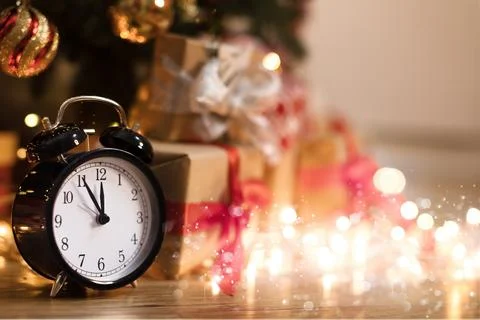 Christmas clock with space for copy, New Year's gold garlands. Stock Photos