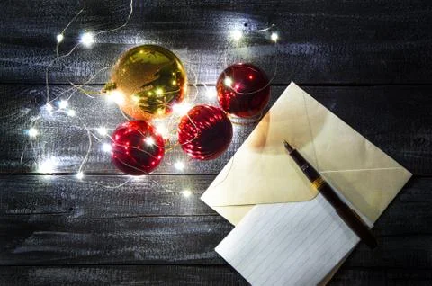 Christmas composition of balls of various sizes and garlands on a dark wooden Stock Photos