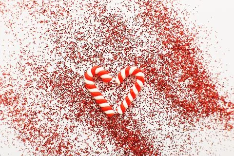 Christmas composition with candy canes in form oh heart on blue wooden backgr 스톡 사진