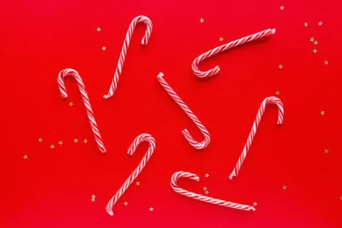 Christmas composition. Candy canes on red paper background. Minimal new year Stock Photos