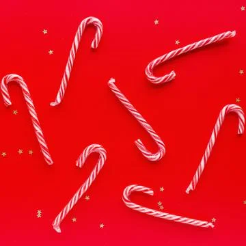 Christmas composition. Candy canes on red paper background. Minimal new year Stock Photos