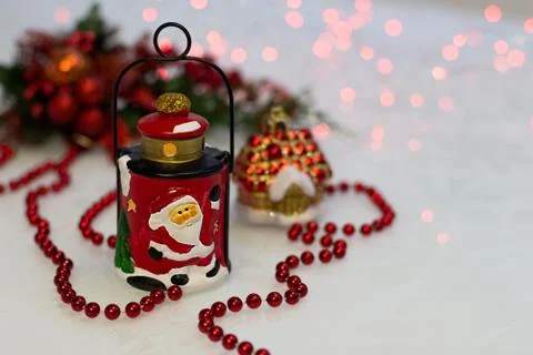 Christmas composition with ceramic lantern, red beads, Christmas decorations Stock Photos
