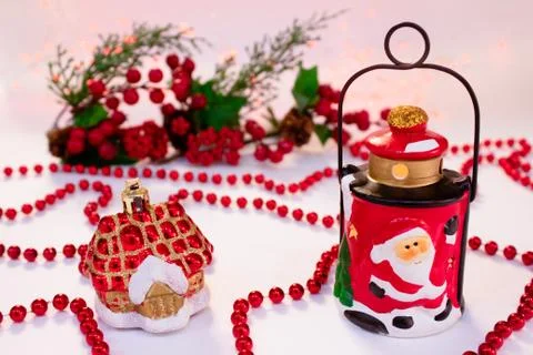 Christmas composition with ceramic lantern, red beads. Christmas card Stock Photos