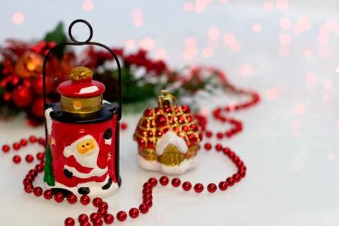 Christmas composition with ceramic lantern, red beads Stock Photos
