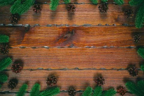 Christmas composition. Christmas frame with pine cones, fir branches on woode Stock Photos