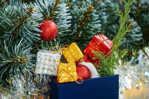 Christmas composition with Christmas tree branches, red tinsel, gift boxes .. Stock Photos