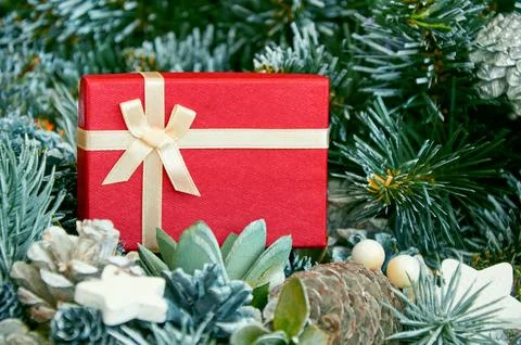 Christmas composition with Christmas tree branches, red tinsel, gift boxes .. Stock Photos
