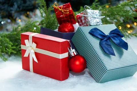 Christmas composition with Christmas tree branches, red tinsel, gift boxes .. Stock Photos