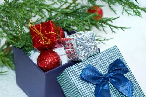 Christmas composition with Christmas tree branches, red tinsel, gift boxes .. Stock Photos