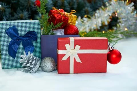 Christmas composition with Christmas tree branches, red tinsel, gift boxes .. Stock Photos