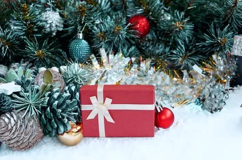 Christmas composition with Christmas tree branches, red tinsel, gift boxes .. Stock Photos