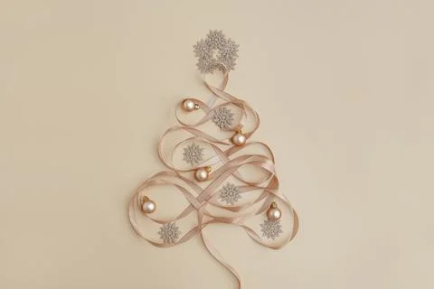 Christmas composition. Christmas tree made of golden balls on beige backgroun Stock Photos