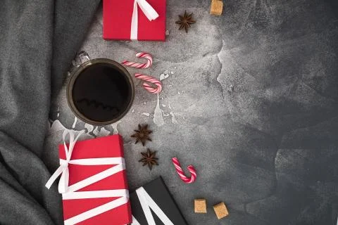Christmas composition with coffee cup, candy, sugar and gifts on gray backgro Stock Photos