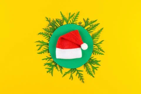 Christmas composition with coniferous tree branches on yellow paper background Stock Photos