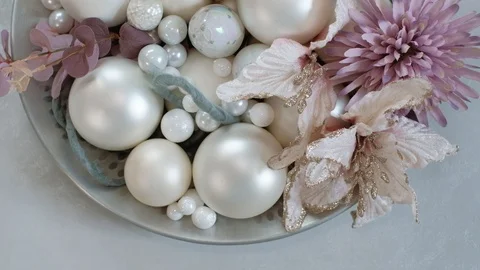 Christmas composition consisting of baubles and flowers in metal dish . 4K Stock Footage 97894844