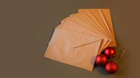 Christmas composition. Craft envelopes and red balls Stock Photos
