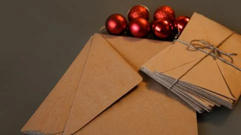 Christmas composition. Craft envelopes and red balls Stock Photos