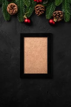 Christmas composition with empty picture frame. Colorful ornament, pine cones Stock Photos