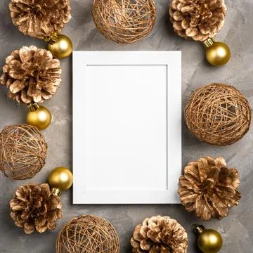 Christmas composition with empty picture frame. Golden ornament, pine cones Stock Photos