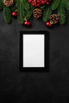 Christmas composition with empty picture frame. Colorful ornament, pine cones Stock Photos