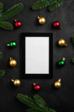 Christmas composition with empty picture frame. Colorful ornament, pine cones Stock Photos