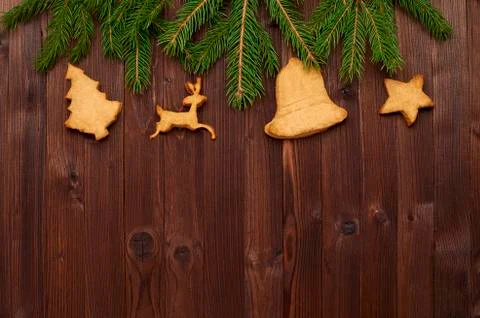 Christmas composition of fir branches and homemade cookies on a wooden backgr Stock Photos