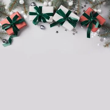 Christmas composition with fir branches tree, red gifts on light background.. Stock Photos