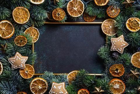 Christmas composition. Frame with gingerbread, pine branches and dried orange Stock Photos