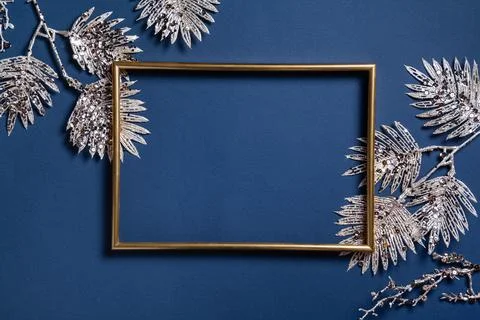 Christmas composition. Frame with golden branches on blue background. Christm Stock Photos