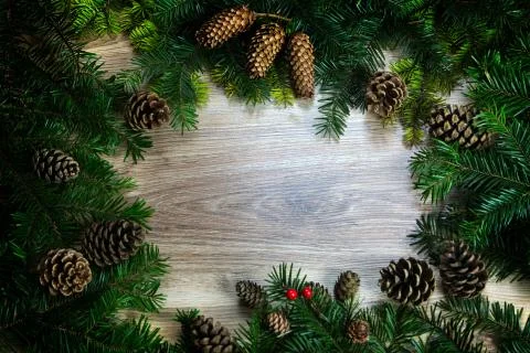 Christmas composition. Frame made of pine branches, fir cones on rustic vinta Stock Illustration