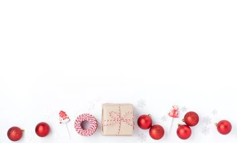 Christmas composition. Frame from red balls, gift, lollipops and snowflakes o Stock Photos