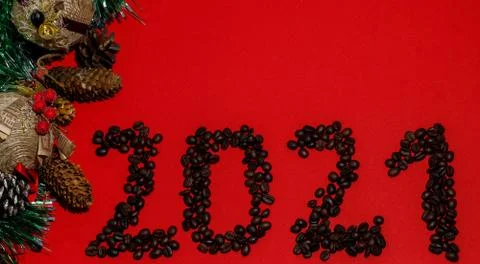 Christmas composition frame for text. Coffee beans 2021 on red background. Fl Stock Photos