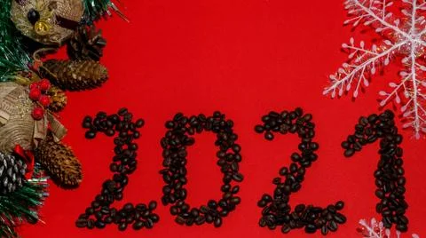 Christmas composition frame for text. Coffee beans 2021 on red background. Fl Stock Photos