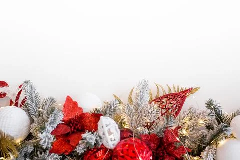 Christmas composition. Garland made of red and white balls and fir tree branches Stock Photos