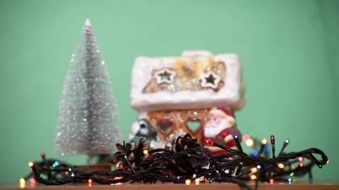 Christmas composition with garland , mini Christmas tree and Santa Claus house Stock Footage 256077677