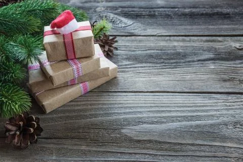 Christmas composition with gift boxes and Santa's cap Stock Photos