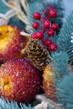 Christmas composition with glazed apples, a slice of orange, pine cones Stock Photos