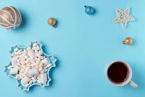 Christmas composition with hot drink, marshmallow and decorations on blue b.. Stock Photos