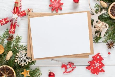 Christmas composition with a kraft envelope and red and white Christmas tree  Stock Photos