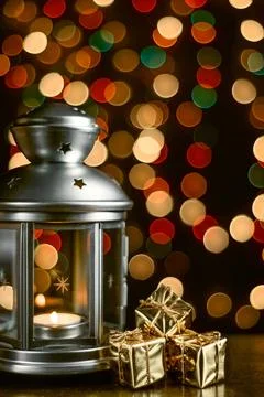 Christmas composition: a lantern with candles, bright shiny boxes with gifts, Stock Photos
